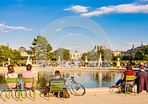 Local and Tourist enjoy sunny days in famous Tuileries garden. Jardin des Tuileries is a public garden located between Louvre