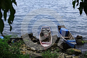 Boats of local fishers were harbored in the rocky beach in Toba Lake, North Sumatra, Indonesia