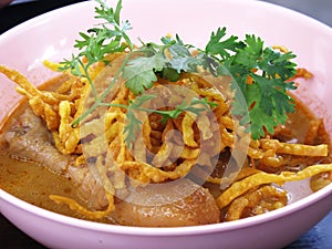 Local traditional thai food khao soi gai or cuisine northern thai curry soup noodles with chicken serve vegetable side dish on