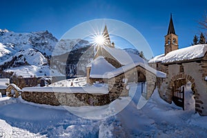 The local village of La Grave and its church with La Meije mountain peak in Winter. Hautes-Alpes, Ecrins National Park, France