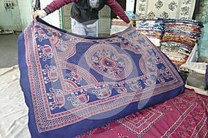 Local weaver displays dhurrie rugs