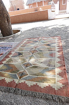 Local weaver displays dhurrie rugs