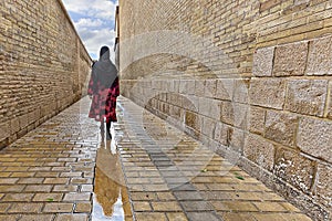 Local woman walking in the ancient street in Shiraz, Iran
