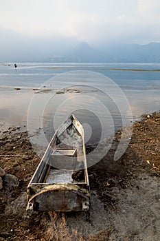 Local wooden fishermen canoe at the coast along lake Atitlan during sunset in San Pedro la Laguna, Guatemala