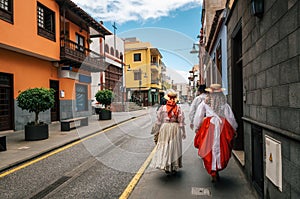 Locals in Canarian traditional clothes walk along the street of Puerto de la Cruz. Day of Canary Islands. Tenerife.