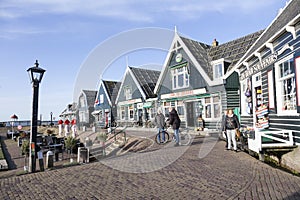 Locals and tourists at harbor of old dutch village Marken