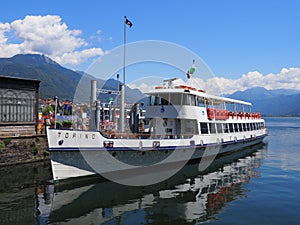 Paddle-wheel steam boat moored ready to cruise at promenade on alpine Lake Maggiore landscape in Locarno at Switzerland