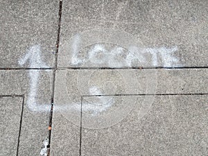 Locate sign painted on asphalt with arrows