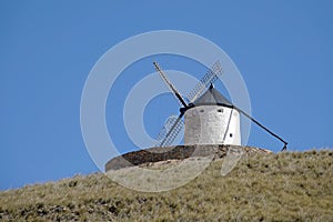 White Windmill on hill in Consuegra, Spain photo