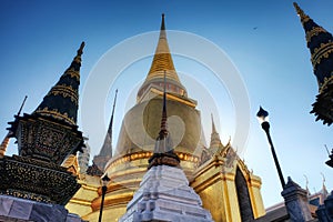 Located in Thailand, this temple boasts a huge golden stupa and a few ornate spires of smaller sizes. The details of the structure