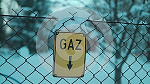 Location plate for gas pipeline in Poland. Yellow aluminum sign, information plaque with arrow pointing down. Letters in