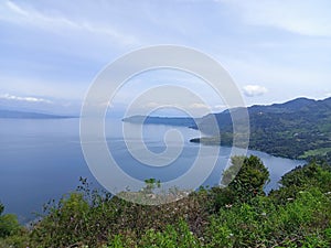 the location of the view of Lake Toba and lake water is clean and blue from the top of the hill