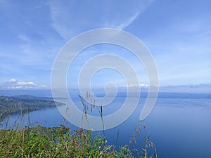 the location of the view of Lake Toba and lake water is clean and blue from the top of the hill