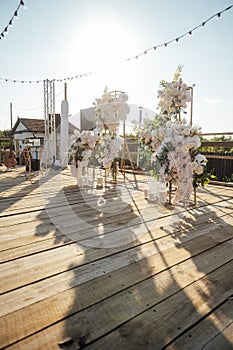 Location for a wedding ceremony on a plank floor. Evening sunset.