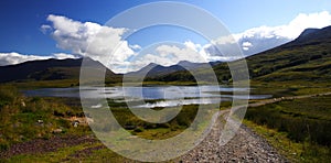 Loch in the highlands and rural path