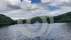 Loch Katrine with a boat sailing across the water in the Trossachs National Park