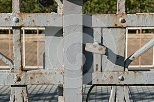 lock an ancient wrought iron gate. door security priority. ancient lock with rust stains, on historic gate.