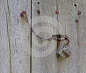 Lock and chain on old wooden door