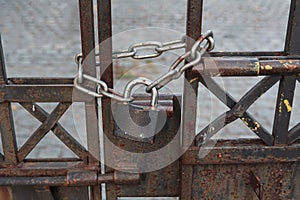 Lock and chain on an rusty gate