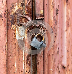 Lock on a chain on a rusty metal container