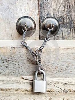 Lock and Chain on Wooden Door