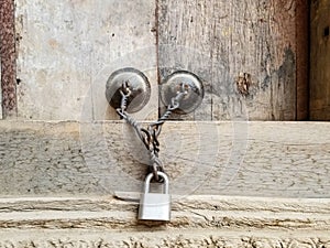 Lock and Chain on Wooden Door