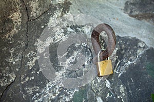 the lock is fastened to the iron rod. big piece of rock. love symbol