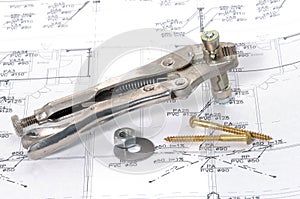 Lock grip pliers over house plan