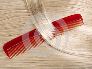 Lock of hair with red comb.