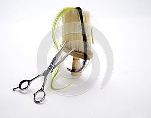 Lock of hair, scissors and brush