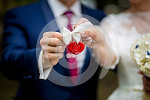 The lock in hands of the newly married couple, closeup.