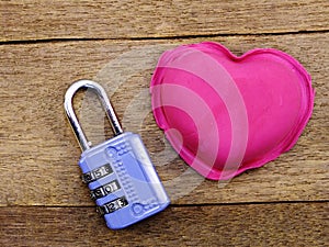 Lock with the heart as a symbol of love vintage on wooden background