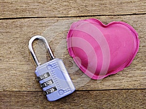 Lock with the heart as a symbol of love on wooden background