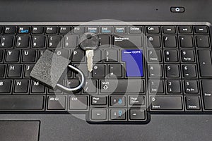 lock, key and blue keyboard key with text GDPR as symbol for Privacy and General Data Protection Regulation on a notebook computer