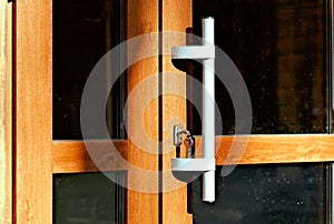 Lock and key. Modern wooden door with a convenient large handle and lock. Entrance to the building, cafe, home, restaurant