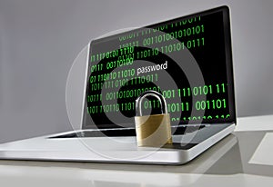 Lock on keyboard of computer laptop with binary code and password text on screen in hacker attack concept