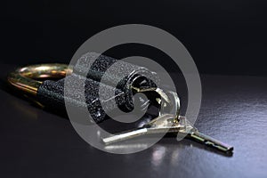 Lock with keys on a black background. Metal padlock close-up