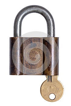 Lock and keys. Closeup of a old brass padlock with key inside isolated on a white background. Macro photograph of antique metal