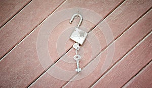 Lock with keys on wooden background concept
