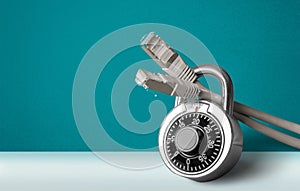 Lock and network cable on light background