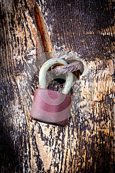 Lock and old latch on wooden door close-up