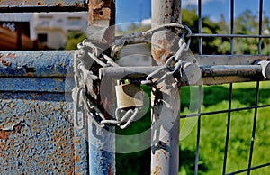 A lock on an old rusty gate