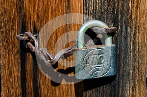 Lock on an old wooden door with rusty inserts