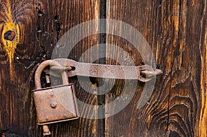 Lock on an old wooden door with rusty inserts