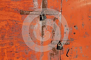 The lock on the rusty metal gate on the garage