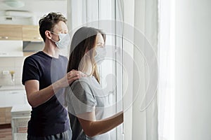 Lockdown. Couple Looking Out The Window on Quarantine.