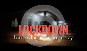 `Lockdown. home is the best place to stay` wordings on a blurred image of a house. photo