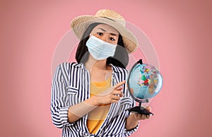 Sad Asian Woman Holding Globe, Wearing Face Mask