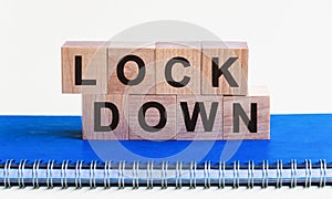 Lockdown, word cube with blue background. Business concept