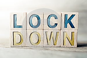 Lockdown Written On Wooden Blocks On A Board - Pandemic Behavior Concept photo